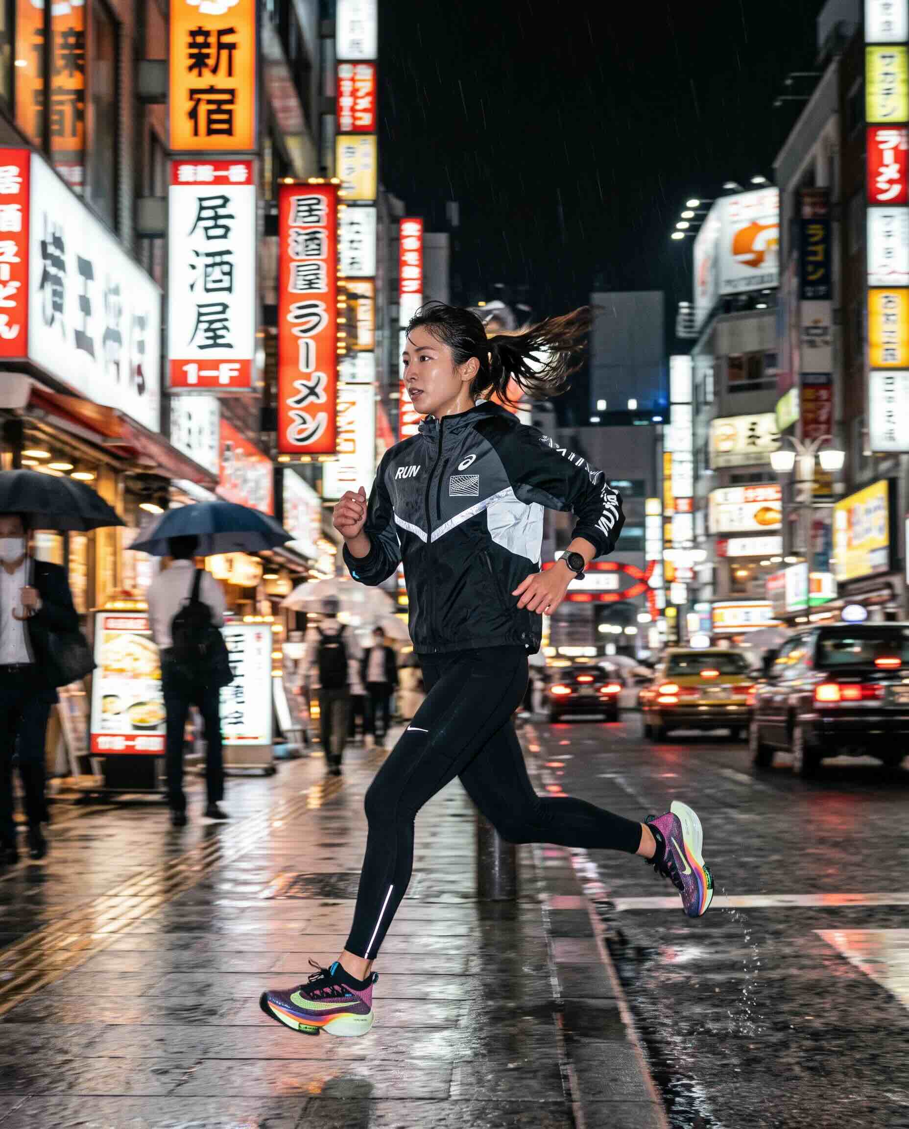 A runner mid-stride on a rain-soaked Shinjuku street at night, neon signage reflected in the wet pavement